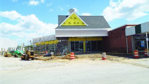 The Newark Shopping Center at 230 E. Main Street is undergoing renovations that include the addition of a pedestrian walkway, and updated signage. A separate developer is constructing upscale apartments behind the shopping center.