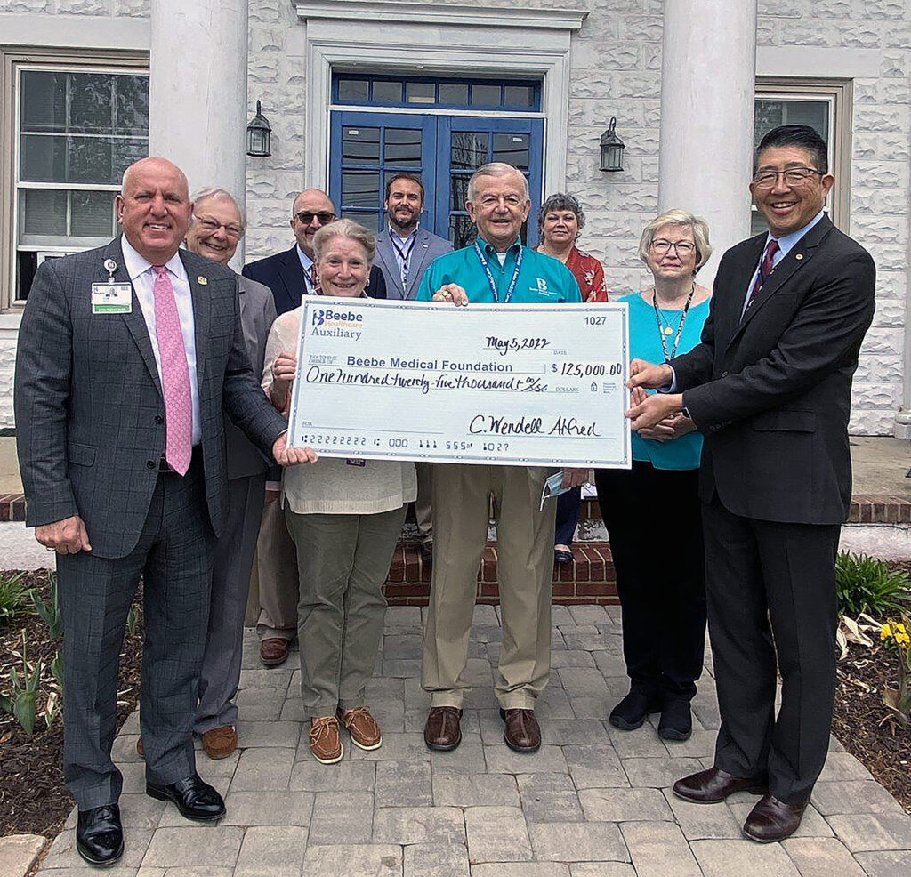 Beebe Healthcare, Beebe Healthcare accepts a very generous donation from its Auxiliary members. Left to Right in photo are Tom Protack, Rosey Vanderhoogt, Rick Schaffner, Patricia Barry, Dr. Bill Chasanov, Wendell Alfred, Lynn Wilkins, Nancy Almacy and Dr. David Tam.
